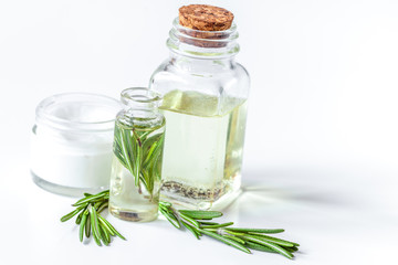 organic cosmetics with extracts of herbs rosemary on white backg