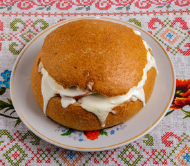 Bread with sausage, cheese and sour cream on a plate on the table. The view from the top.