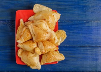 Puff pastry with filling on a plate on the table.