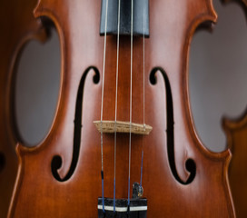 In selective focus of wooden violin,show texture of wood and detail of violin