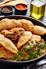 close-up of deep fried turnovers or chebureki