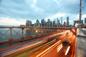 Buildings and transportation on Brooklyn bridge in night New York.