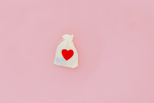 White bag with red hart on a pink backgound. Snt Valentines day, 14 February and love day. Love concept. Horizontal and vertical pictures.