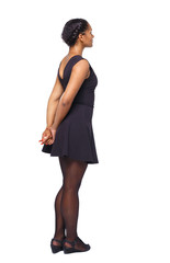 Side view of black woman in a brown dress.