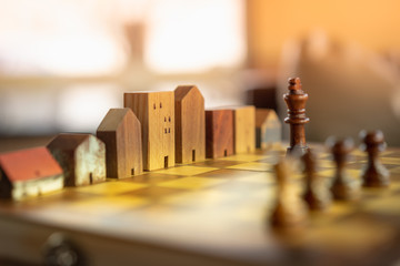 Building and house models in chess game, Business financial district and commercial , success and...