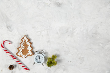 Christmas holiday background with vintage alarm-clock, Candy canes wooden background. Close-up, top view.