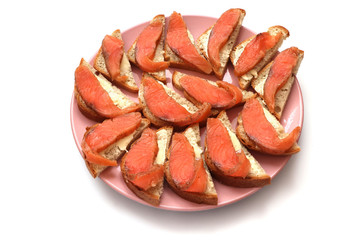 sandwich with salmon on a plate on a white background