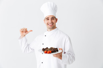 Cheerful chef cook wearing uniform peppers