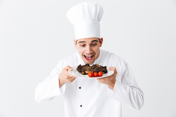 Cheerful chef cook wearing uniform peppers