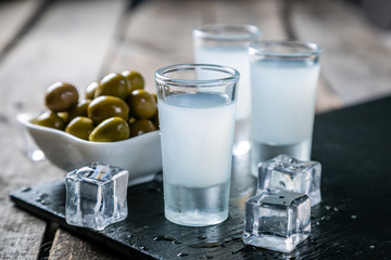 Traditional greek vodka - ouzo in shot glasses - obrazy, fototapety, plakaty