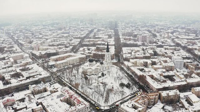 Aerial drone footage flying low over old downtown of Odesssa, Ukraine in winter time. City covered with snow