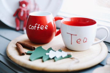 Mugs with tea and coffee on a wooden tray.  Winter, New Year, Christmas concept.