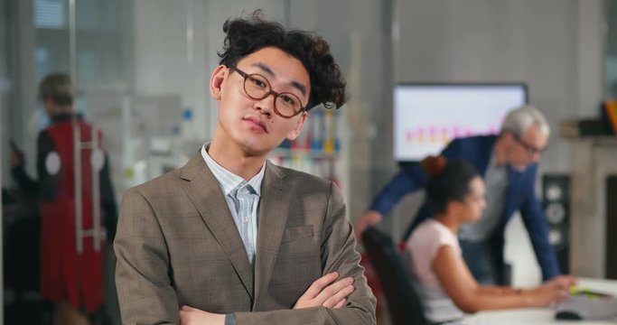 Image of young successful asian office employee