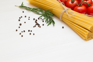 Italian pasta ingredients on white wooden table, macro