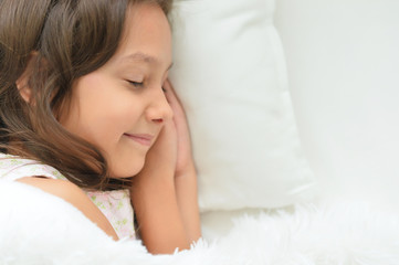 Portrait of cute little girl sleeping in bed