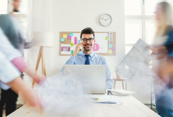 Young businesspeople in a modern office, having meeting. Motion blur.