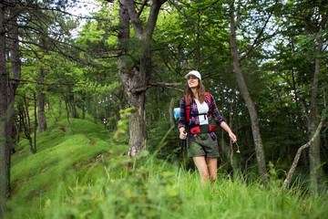 Young female hiker with backpack in a forest