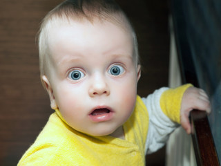 little boy looks with a frightened look into the camera. close-up