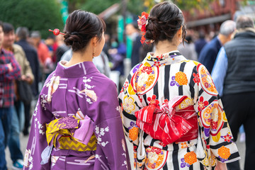 Young girl wearing Japanese kimono standing in front of Sensoji Temple in Tokyo, Japan. Kimono is a Japanese traditional garment. The word "kimono", which actually means a "thing to wear"