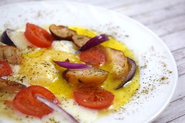 Delicious scrambled eggs with tomatoes and sausages for Breakfast.