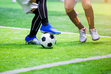 Obraz premium Kid soccer players trap and control the ball for shoot to goal.