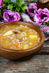 Pickle soup on old wooden table.