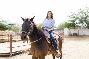Rancher Smiling While Riding Brown Horse