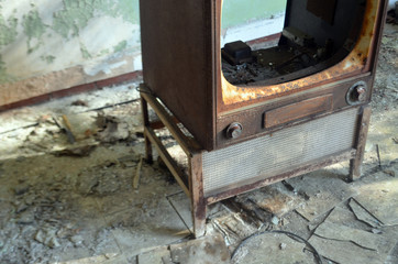 Rusty broken tv television set inside of abandoned house