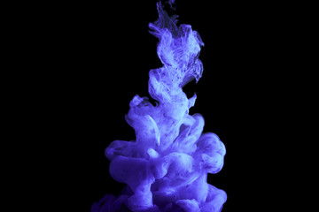 paint stream in water, colored cloud, abstract background, process of liquefaction volet dye on a black background