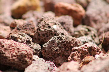 Close-up of lava rock. Focus is on center foreground, surrounding rocks are out of focus.