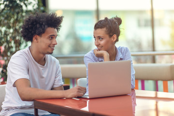 Two freelance working in coffee shop, Nomad worker conceptual, couple work together in cafe with laptop