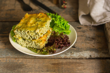 pasta casserole - penne, cheese, spinach, broccoli - main dish  (dark background). top view. copy space