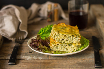 pasta casserole - penne, cheese, spinach, broccoli - main dish  (dark background). top view. copy space