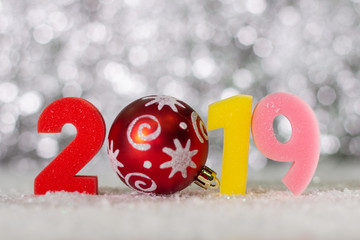 Number 2019 close-up on the background of holiday lights. The concept of a new 2019.