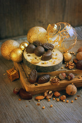 festive still life with chocolate candy in Christmas decorations. selective soft focus, toning