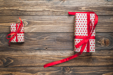 Fototapeta premium gift boxes with red ribbon on wooden table