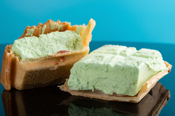 studio shoot  of ice cream block on blue with reflection