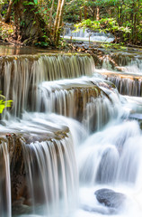 Naklejka premium Waterfall flowing from the mountains at Huay Mae khamin waterfall National Park ,Kanchana buri in Thailand.