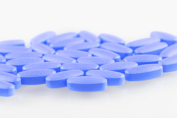 blue pills on a white background