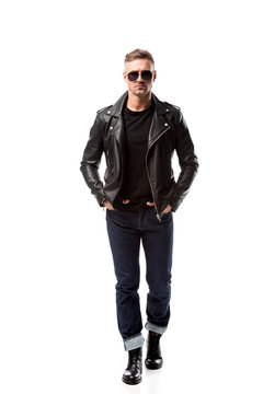 stylish adult man in leather jacket with hands in pockets isolated on white