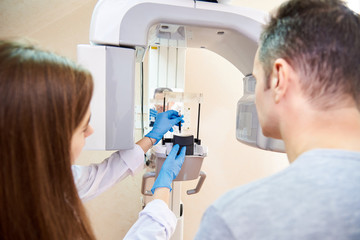 doctor and patient next to x-ray machine. Computer diagnostics. dental tomography