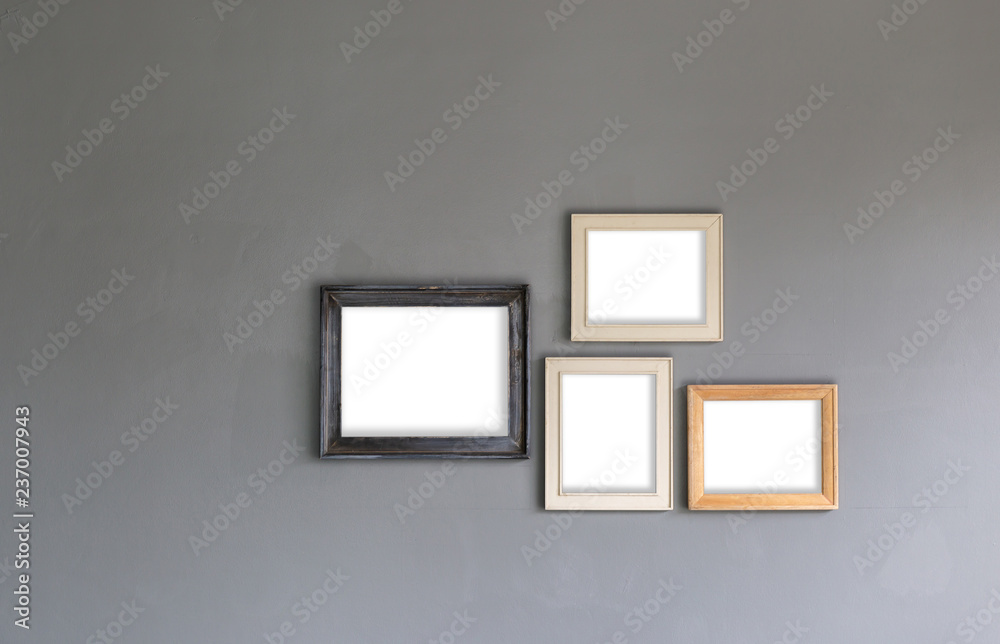 Wall mural group of blank photo frames on the wall for your design