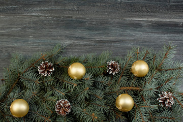 Christmas composition of fir branches and Christmas tree decorations on a wooden background . Top view with copy space