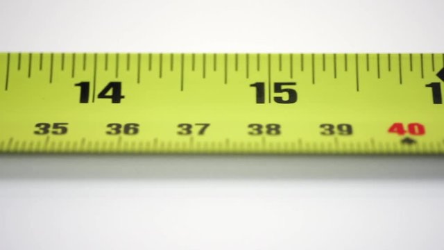 Tape measure close up HD footage against white background with a sliding camera move