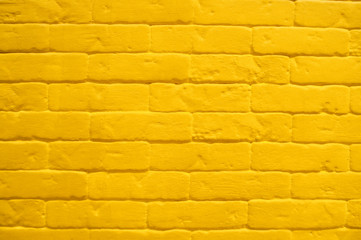 Background of bright yellow brick wall texture.