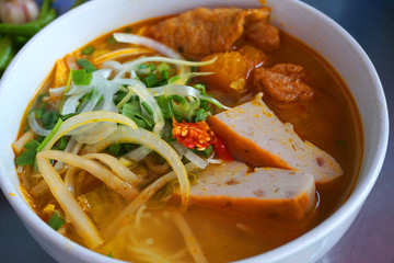  Bun Cha Ca - Delicious grilled catfish fish caked noodles Da Nang signature dish Vietnamese food Asian cuisine with red green chilly herb tomato onion lettuce spinach tomato pork stock 