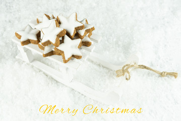 Obraz na płótnie Canvas Sleigh with delicious Christmas cookies in the snow, card