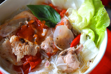 Vietnamese traditional food rice noodles with grilled pork spring onion, peanut, spring roll,...