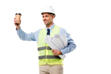 smiling engineer in safety vest holding blueprints and coffee to go isolated on white