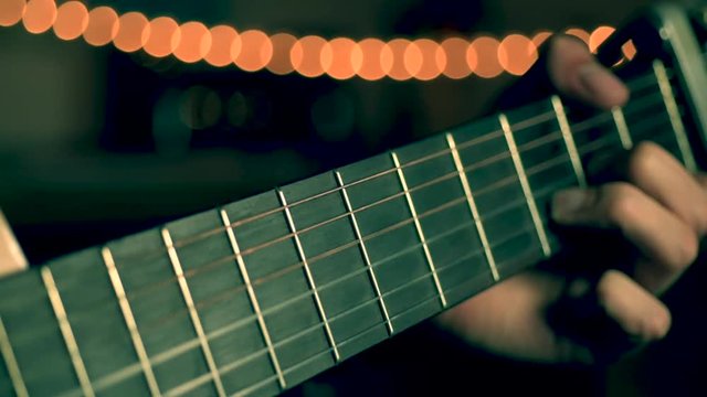 Playing Acoustic Guitar close up of fret board guitar neck